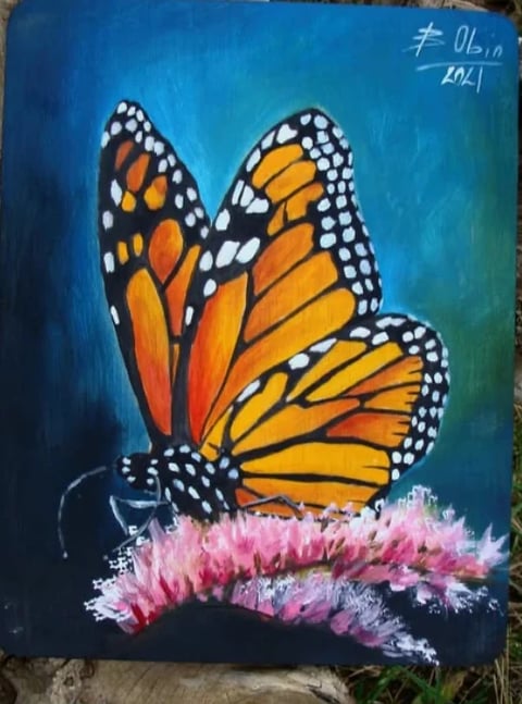 Acrylic painting of a monarch butterfly with orange and black wings resting on a pink flower against a blue-green background